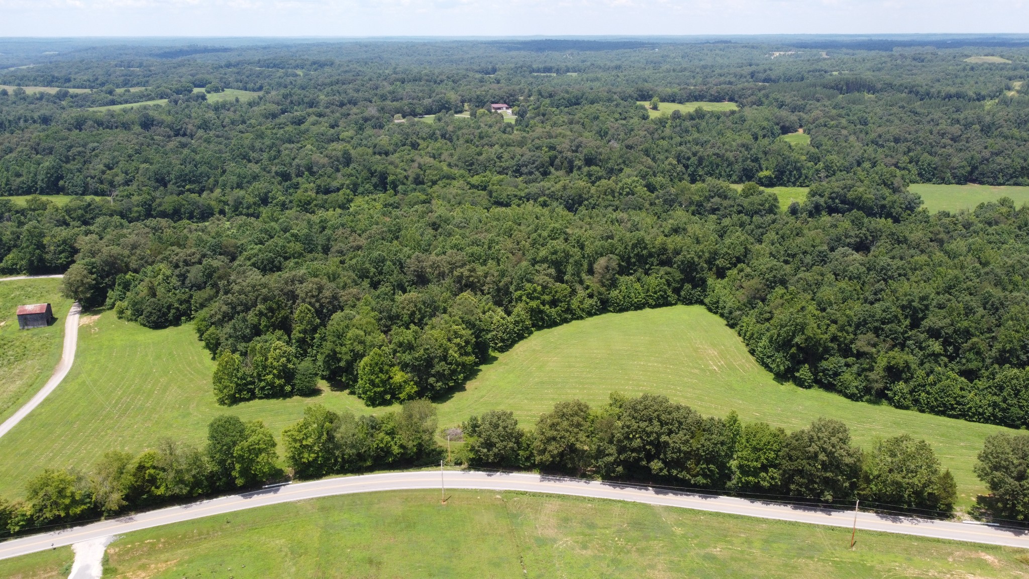 an aerial view of a house with a yard and lake view