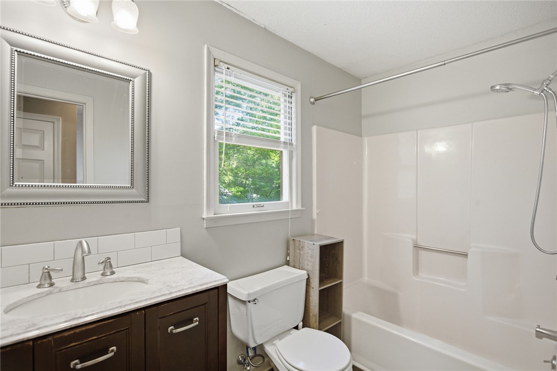 100 Henry Court Central, SC 29630 - Photo 17 of 39 This bright bathroom features a vanity, toilet, and shower.
