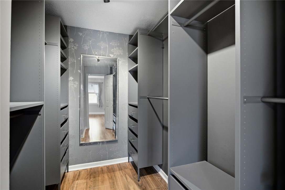 100 Henry Court Central, SC 29630 - Photo 18 of 39 This organized walk-in closet offers extensive storage solutions with built-in shelving and hanging space.