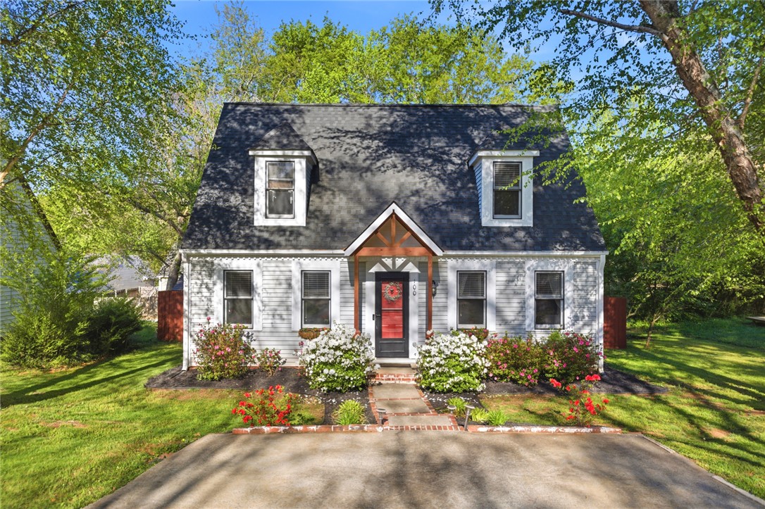 100 Henry Court Central, SC 29630 - Photo 2 of 39 This charming home offers a welcoming facade with meticulous landscaping and vibrant foliage.