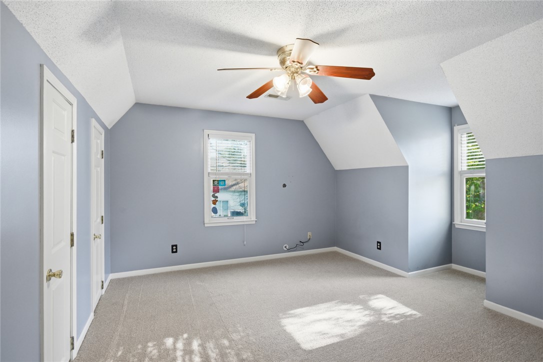 100 Henry Court Central, SC 29630 - Photo 23 of 39 This airy room features sloped ceilings and ample natural light, creating a bright and inviting atmosphere.