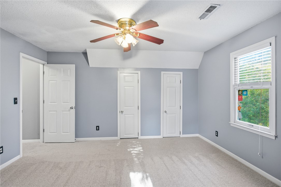 100 Henry Court Central, SC 29630 - Photo 24 of 39 This spacious bedroom offers ample natural light and comfortable carpeting, ready for your personal touch.