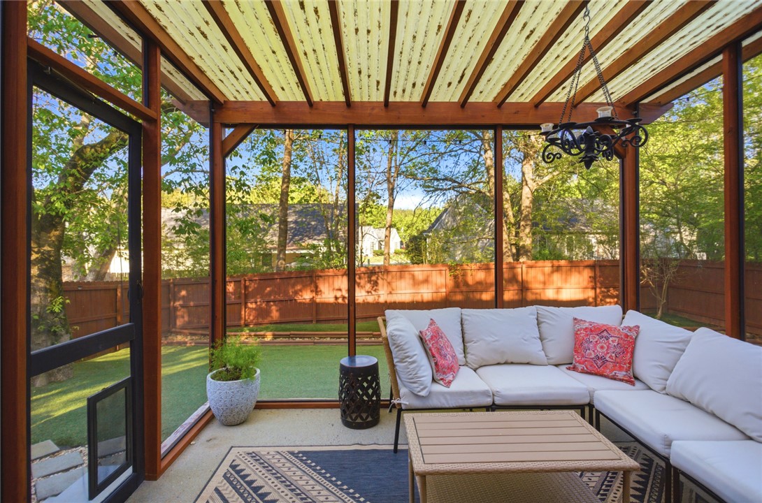 100 Henry Court Central, SC 29630 - Photo 29 of 39 This inviting sunroom with large windows seamlessly connects indoor comfort with outdoor greenery.