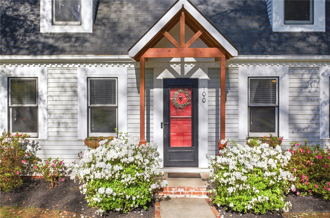 100 Henry Court Central, SC 29630 - Photo 3 of 39 This charming home showcases a vibrant red door, inviting all who approach.