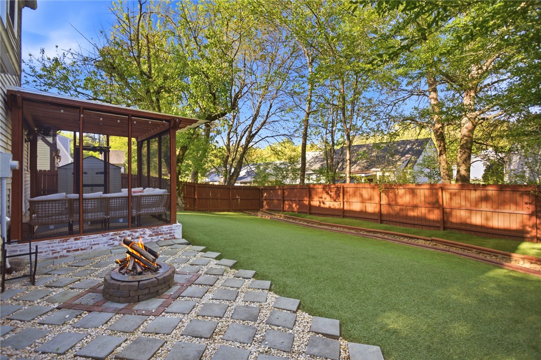 100 Henry Court Central, SC 29630 - Photo 35 of 39 This spacious backyard features a fire pit and screened porch for seamless outdoor enjoyment.