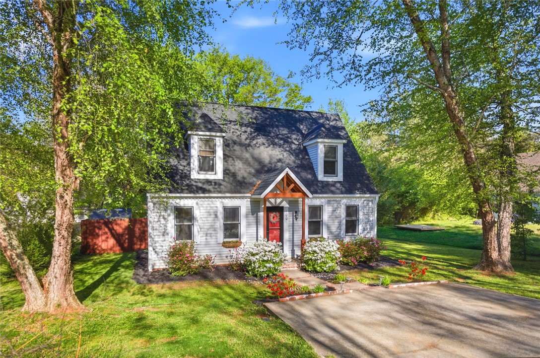 100 Henry Court Central, SC 29630 - Photo 39 of 39 This charming home offers a welcoming facade with mature trees and a vibrant garden.