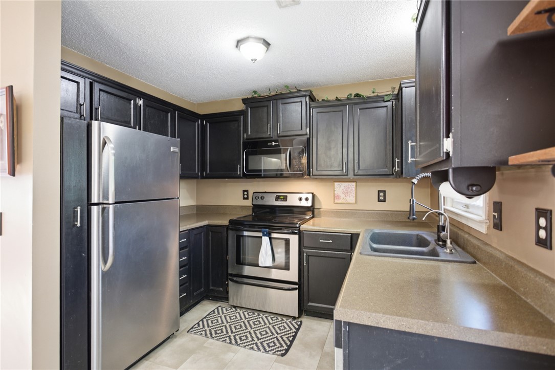 100 Henry Court Central, SC 29630 - Photo 10 of 39 This kitchen showcases stainless steel appliances and ample cabinetry, offering functionality and style.
