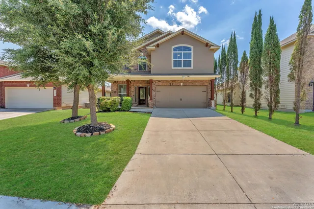 a front view of a house with a yard and garage
