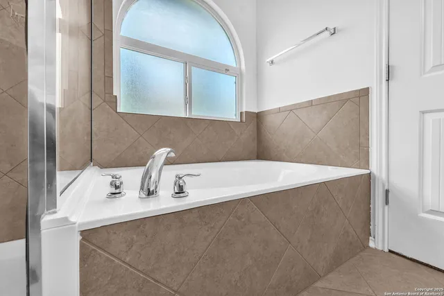 a bathroom with a bathtub and a sink