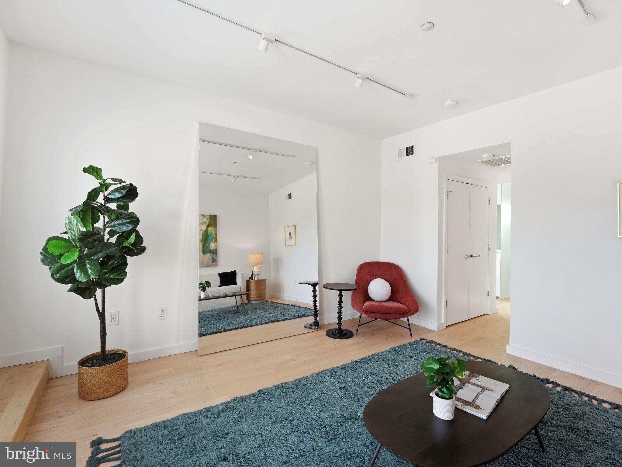 1845 Calvert Street Northwest Washington, DC 20009 - Photo 29 of 48 a living room with furniture and a potted plant