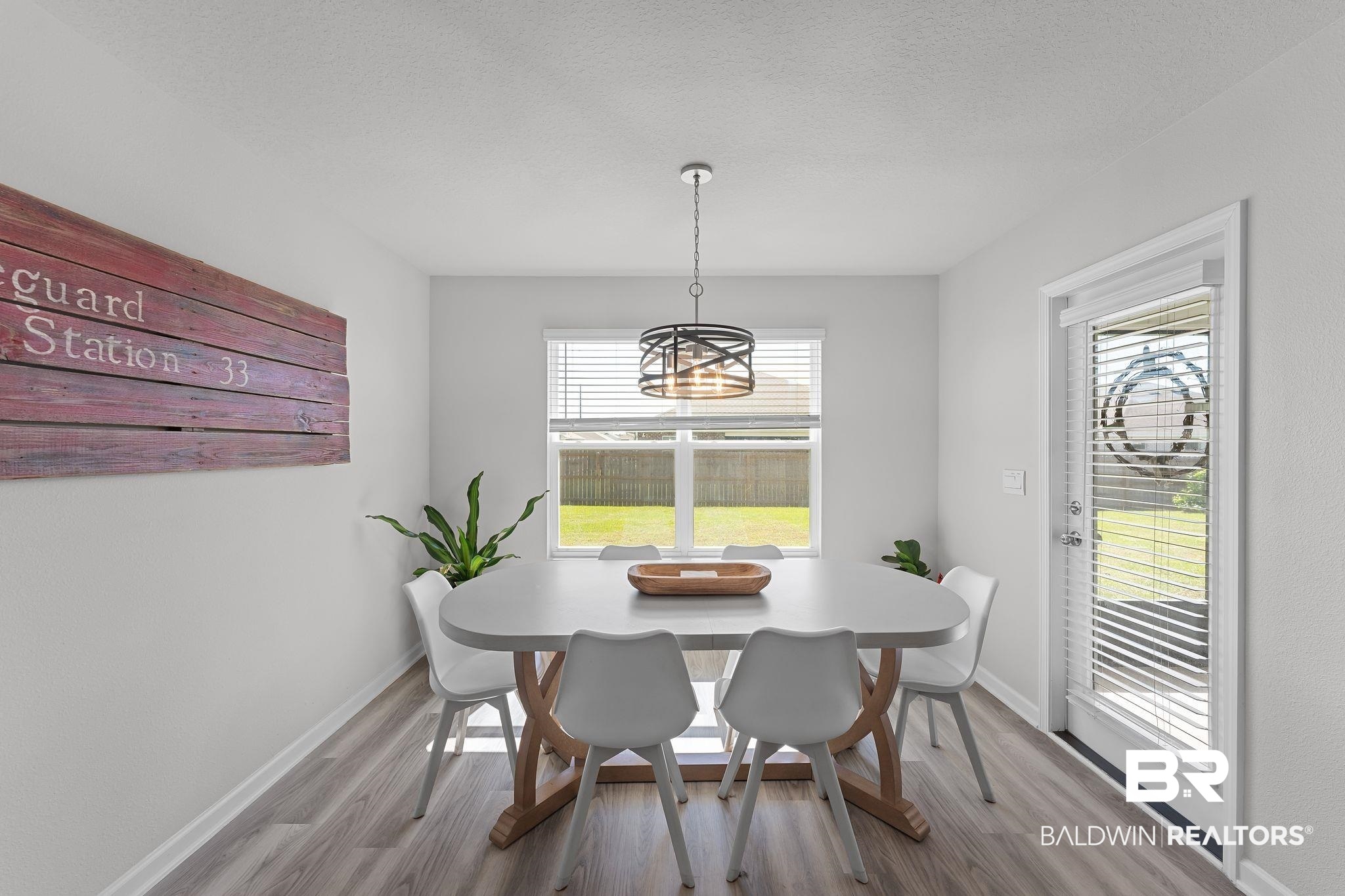 24337 Ringneck Loop Elberta, AL 36530 - Photo 11 of 34 Dining area with healthy amount of natural light, wood finished floors, and a textured ceiling