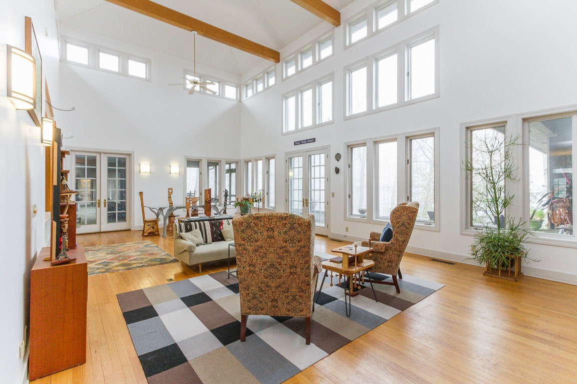 1033 Eva Lake Road Sewanee, TN 37375 - Photo 11 of 49 a living room with furniture and floor to ceiling windows