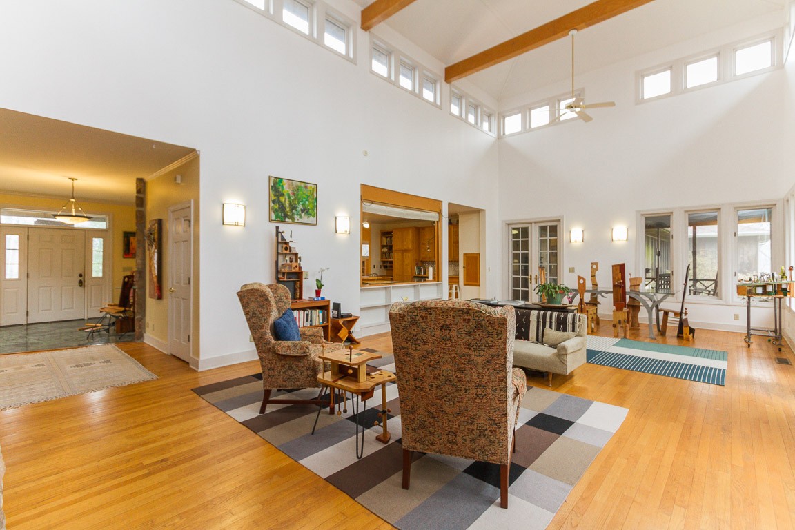 1033 Eva Lake Road Sewanee, TN 37375 - Photo 12 of 49 a living room with furniture a dining table and chairs with kitchen view