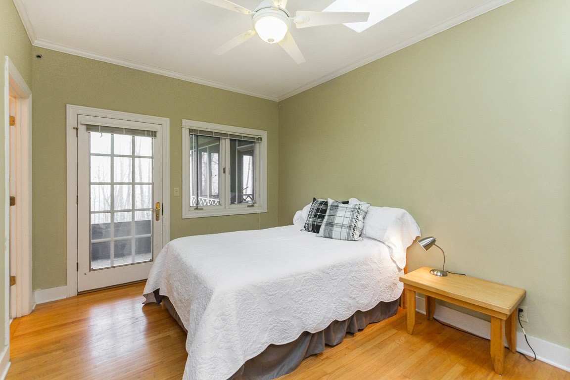 1033 Eva Lake Road Sewanee, TN 37375 - Photo 21 of 49 a bedroom with a bed and wooden floor