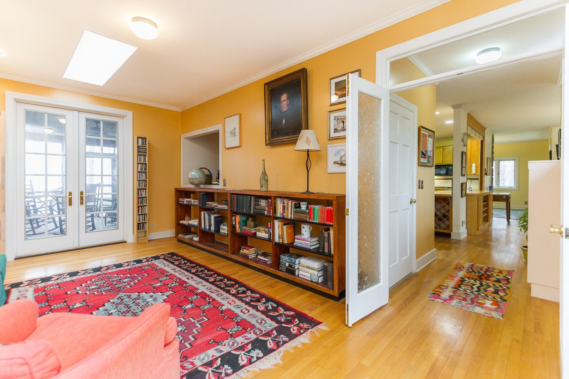 1033 Eva Lake Road Sewanee, TN 37375 - Photo 24 of 49 a view of a bedroom with wooden floor and windows