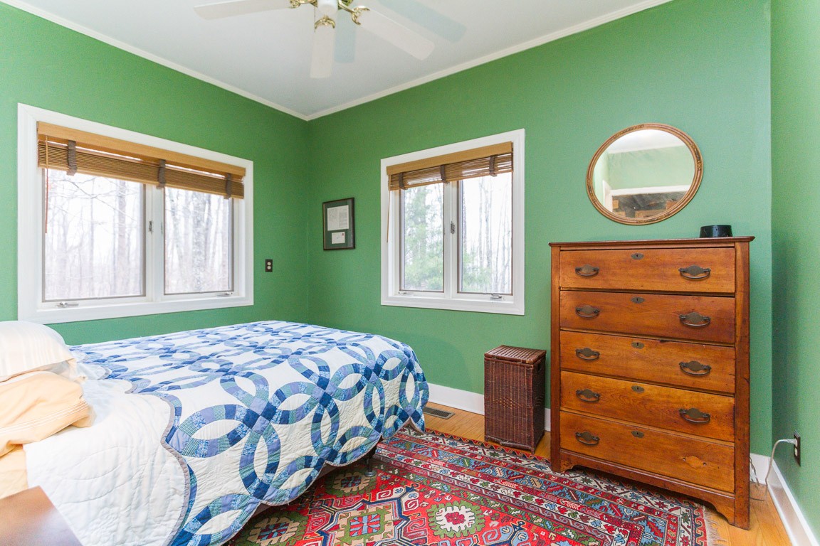1033 Eva Lake Road Sewanee, TN 37375 - Photo 30 of 49 a bedroom with a bed and a dresser