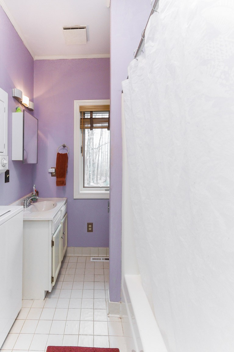 1033 Eva Lake Road Sewanee, TN 37375 - Photo 32 of 49 a bathroom with a granite countertop sink and a mirror