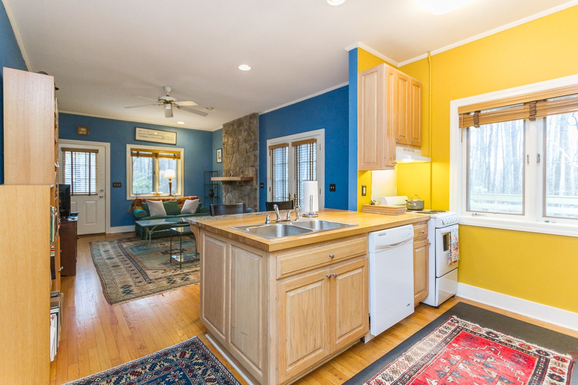 1033 Eva Lake Road Sewanee, TN 37375 - Photo 33 of 49 a kitchen with a stove a sink and a refrigerator