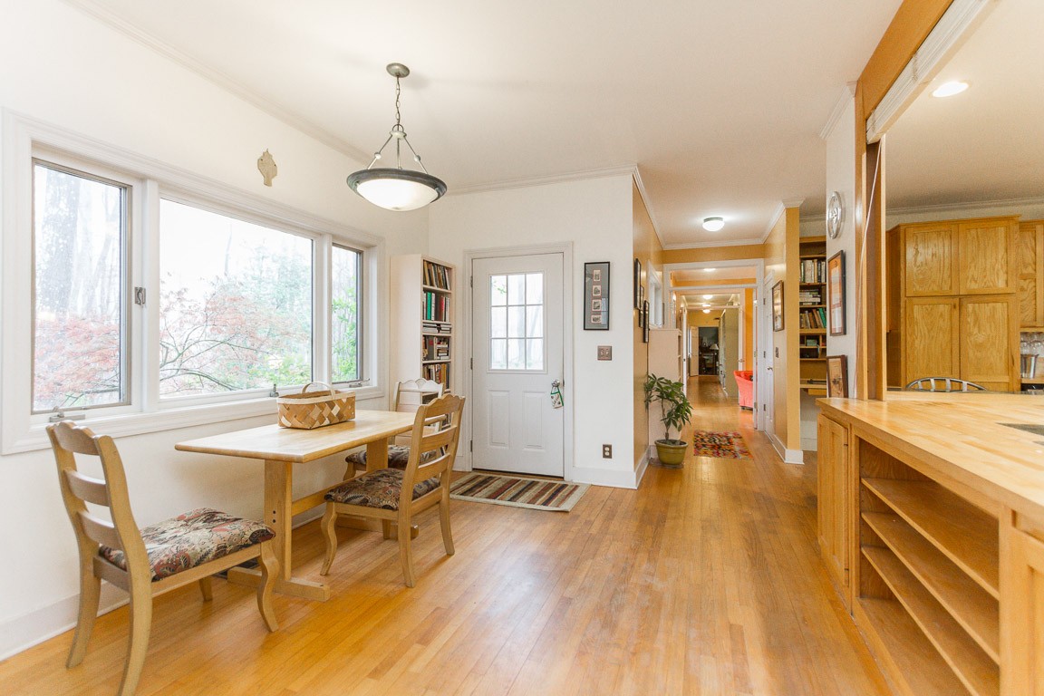 1033 Eva Lake Road Sewanee, TN 37375 - Photo 8 of 49 a view of a dining room and livingroom with furniture wooden floor a chandelier