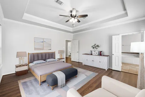 a spacious bedroom with a bed a couch and a chandelier