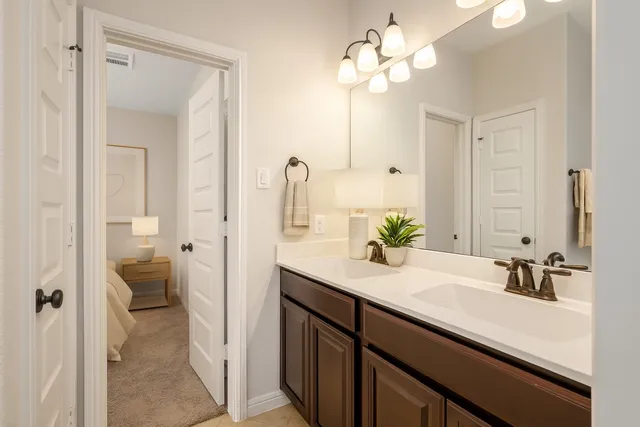 a bathroom with a sink vanity granite and a toilet