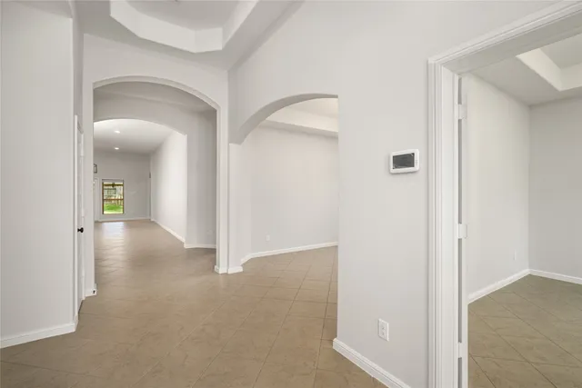 a view of a hallway with closet and a bathroom