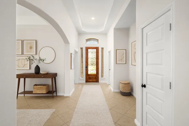 a view of a hallway with entryway wooden floor and front door