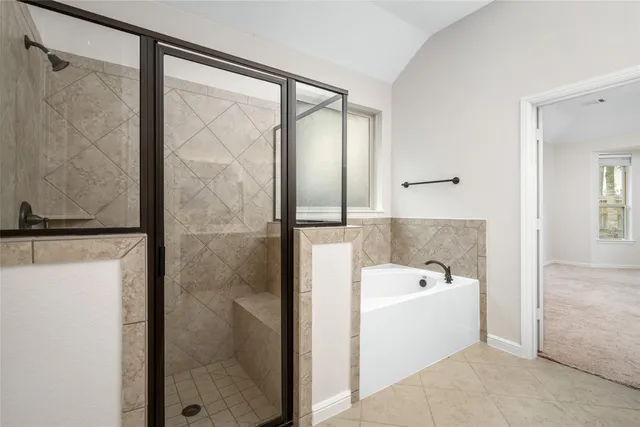 a bathroom with a tub and a shower