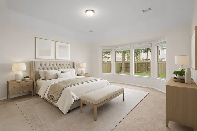 a spacious bedroom with a large bed and a large window