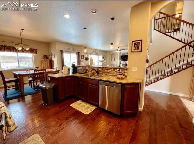 a kitchen with sink refrigerator and window