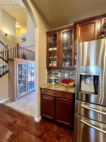 a living room with stainless steel appliances kitchen island granite countertop furniture wooden floor and a kitchen view