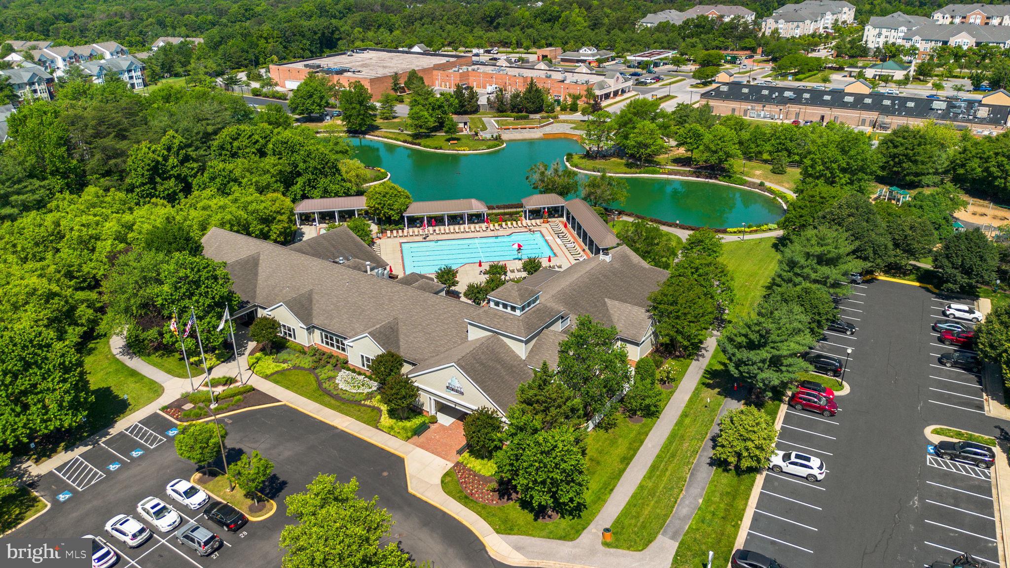 2444 Blue Spring Court, Unit 203 Odenton, MD 21113 - Photo 34 of 36 an aerial view of a house with a garden and lake view