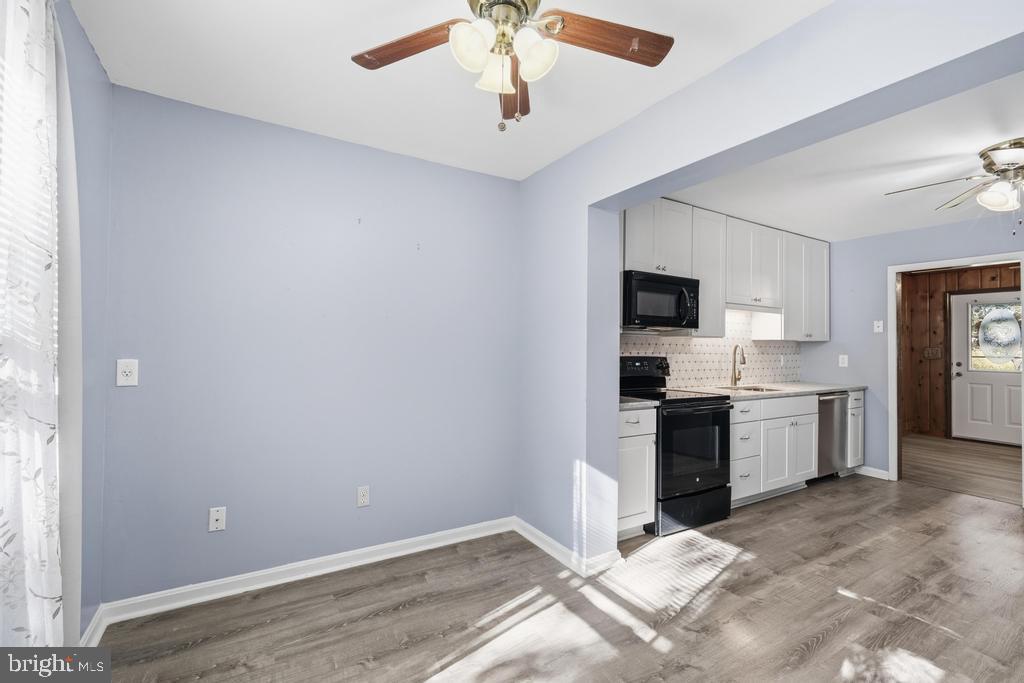1326 Perrys Corner Road Grasonville, MD 21638 - Photo 14 of 35 a large white kitchen with a sink stainless steel appliances and cabinets