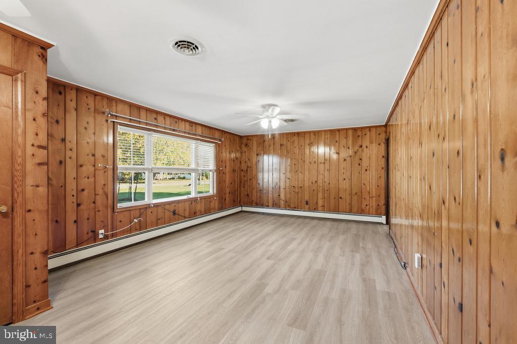 1326 Perrys Corner Road Grasonville, MD 21638 - Photo 18 of 35 a view of an empty room with wooden floor and a window