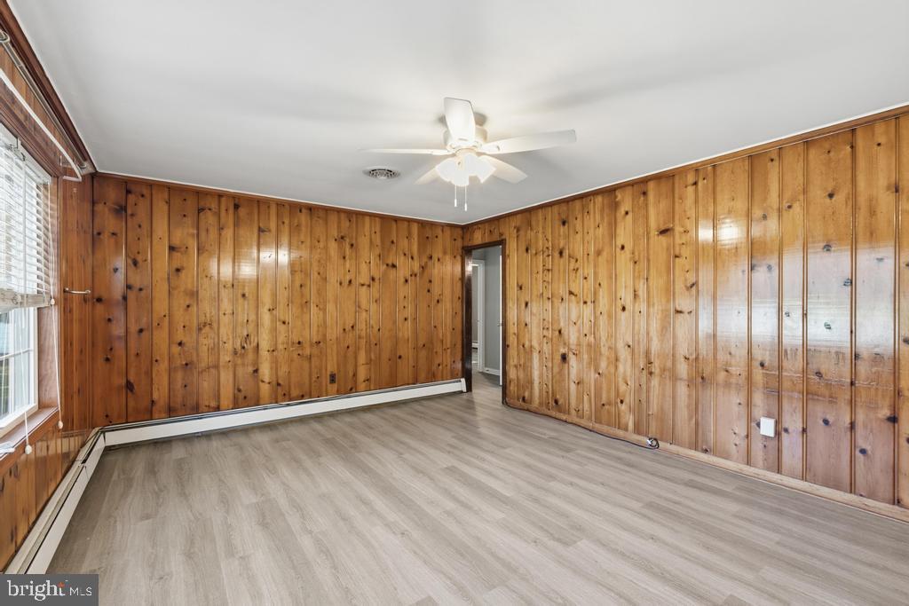1326 Perrys Corner Road Grasonville, MD 21638 - Photo 19 of 35 a view of an empty room with wooden floor and a window