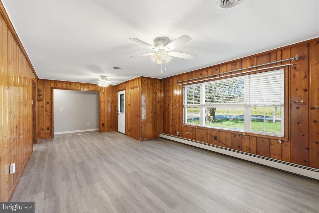 1326 Perrys Corner Road Grasonville, MD 21638 - Photo 20 of 35 a view of an empty room with a window and wooden floor