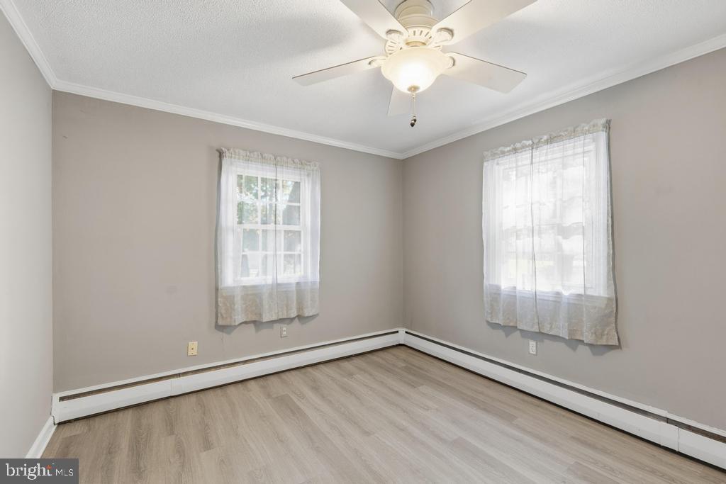 1326 Perrys Corner Road Grasonville, MD 21638 - Photo 24 of 35 wooden floor in an empty room with a window