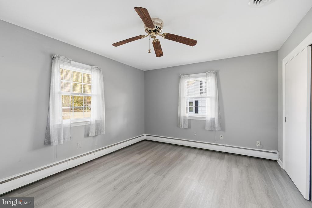 1326 Perrys Corner Road Grasonville, MD 21638 - Photo 26 of 35 wooden floor in an empty room with a window