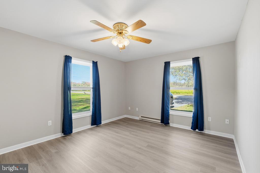 1326 Perrys Corner Road Grasonville, MD 21638 - Photo 28 of 35 an empty room with window and a ceiling fan