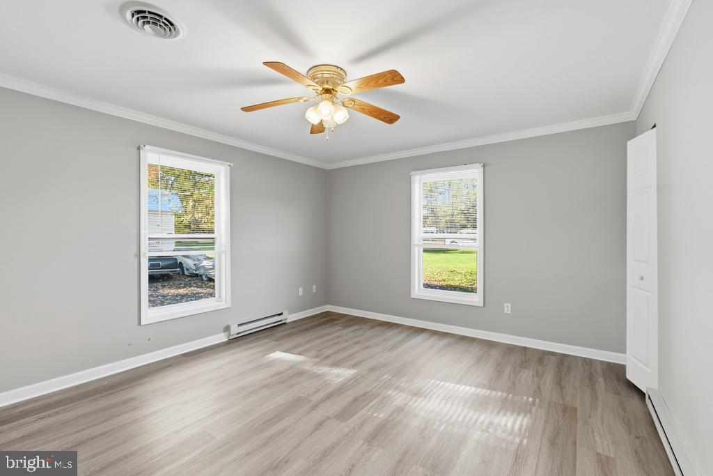 1326 Perrys Corner Road Grasonville, MD 21638 - Photo 31 of 35 a view of an empty room with wooden floor and a window