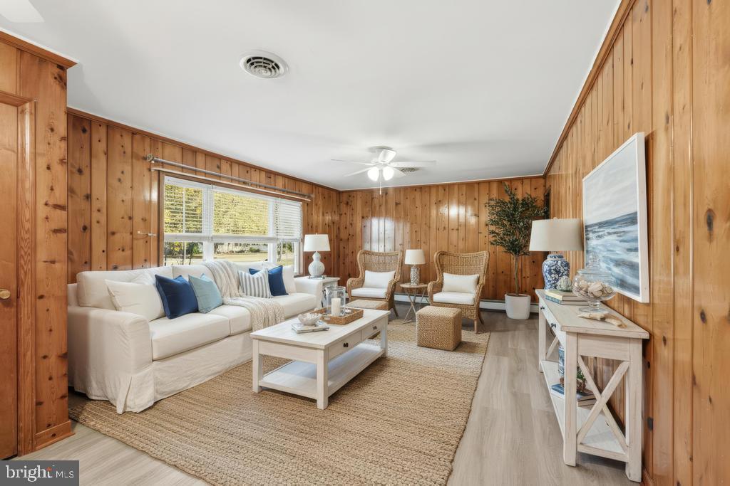 1326 Perrys Corner Road Grasonville, MD 21638 - Photo 4 of 35 a living room with furniture wooden floor and a large window