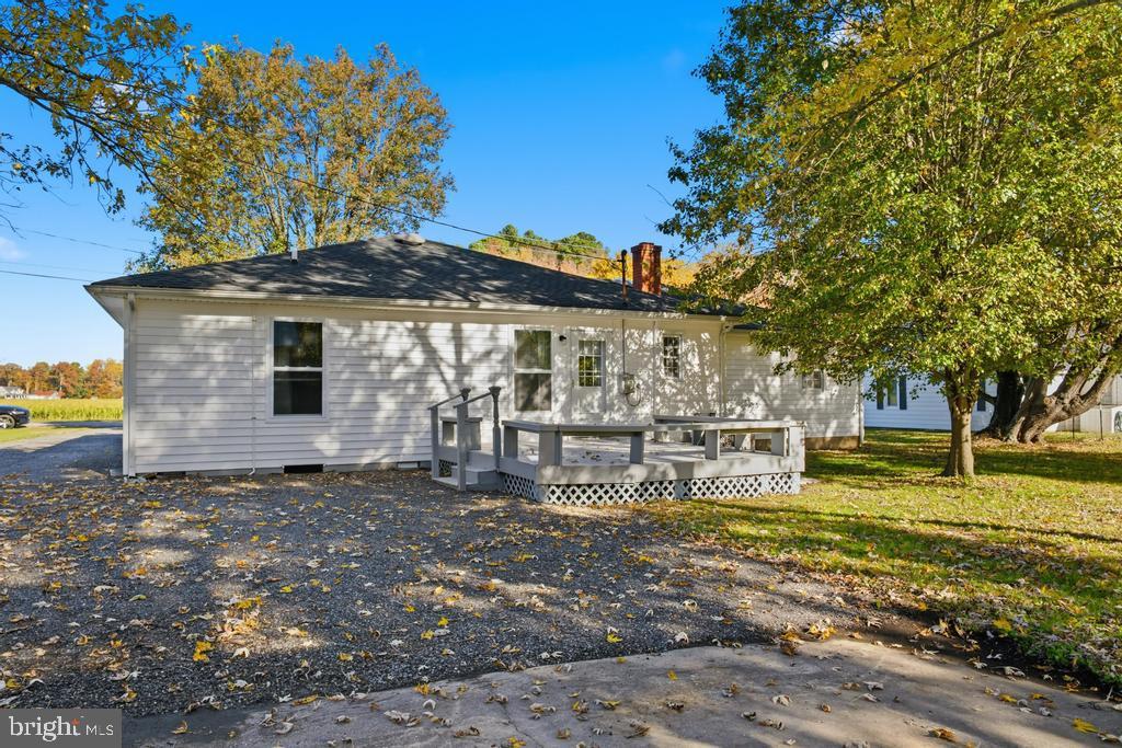 1326 Perrys Corner Road Grasonville, MD 21638 - Photo 8 of 35 a backyard of a house with table and chairs
