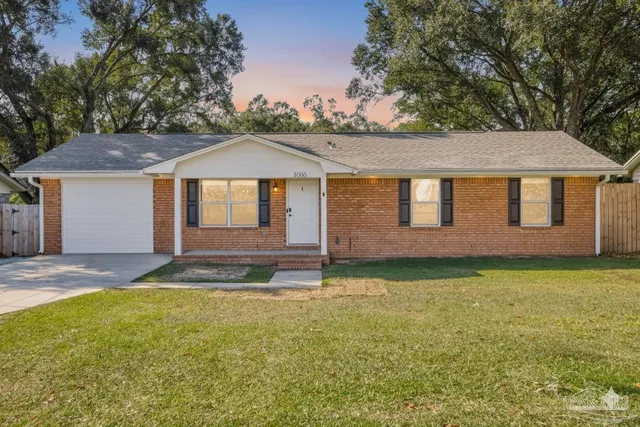 a living room with furniture a flat screen tv and a large window
