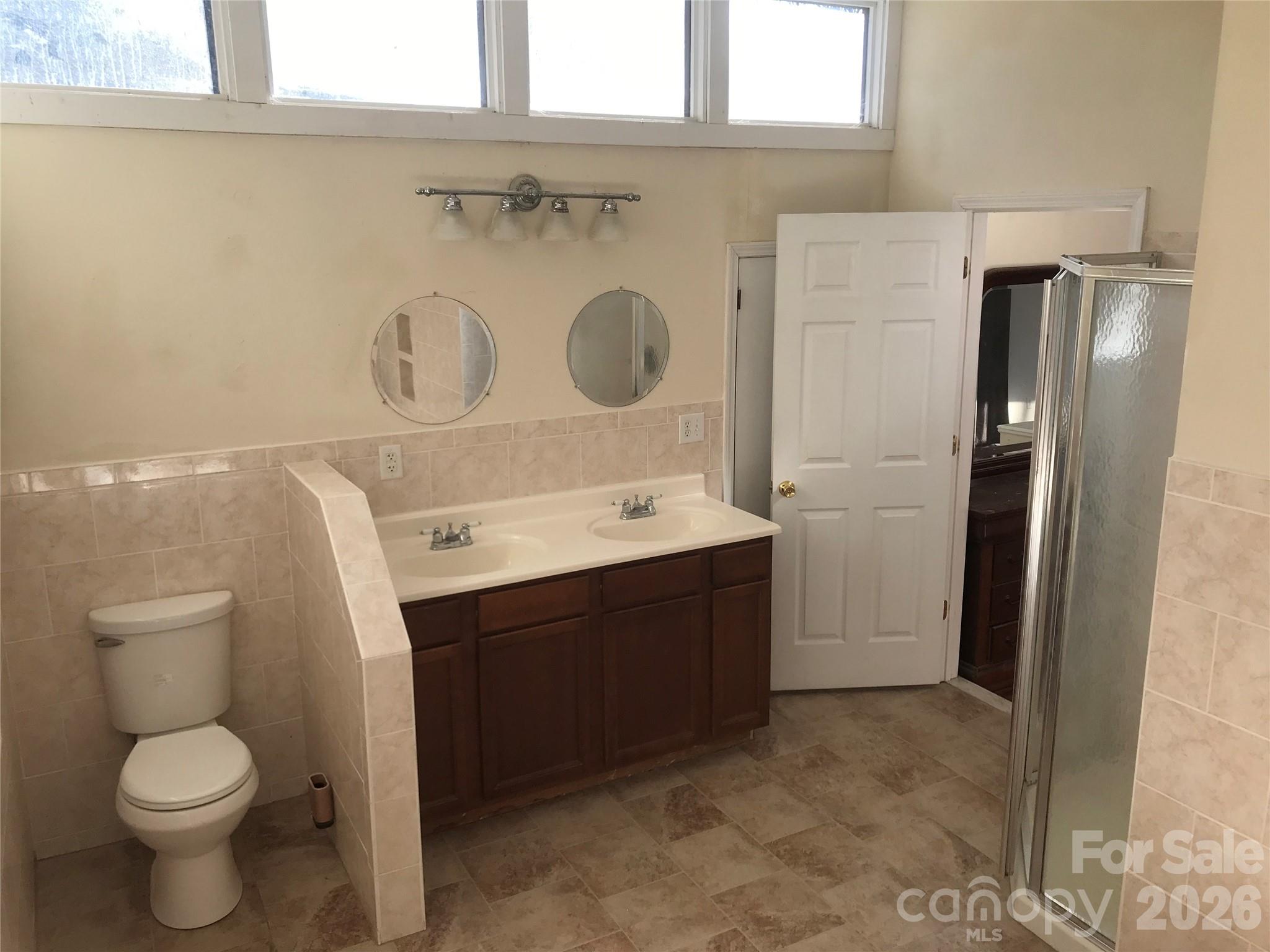 545 Avery Creek Road Arden, NC 28704 - Photo 26 of 35 a bathroom with a toilet sink and mirror
