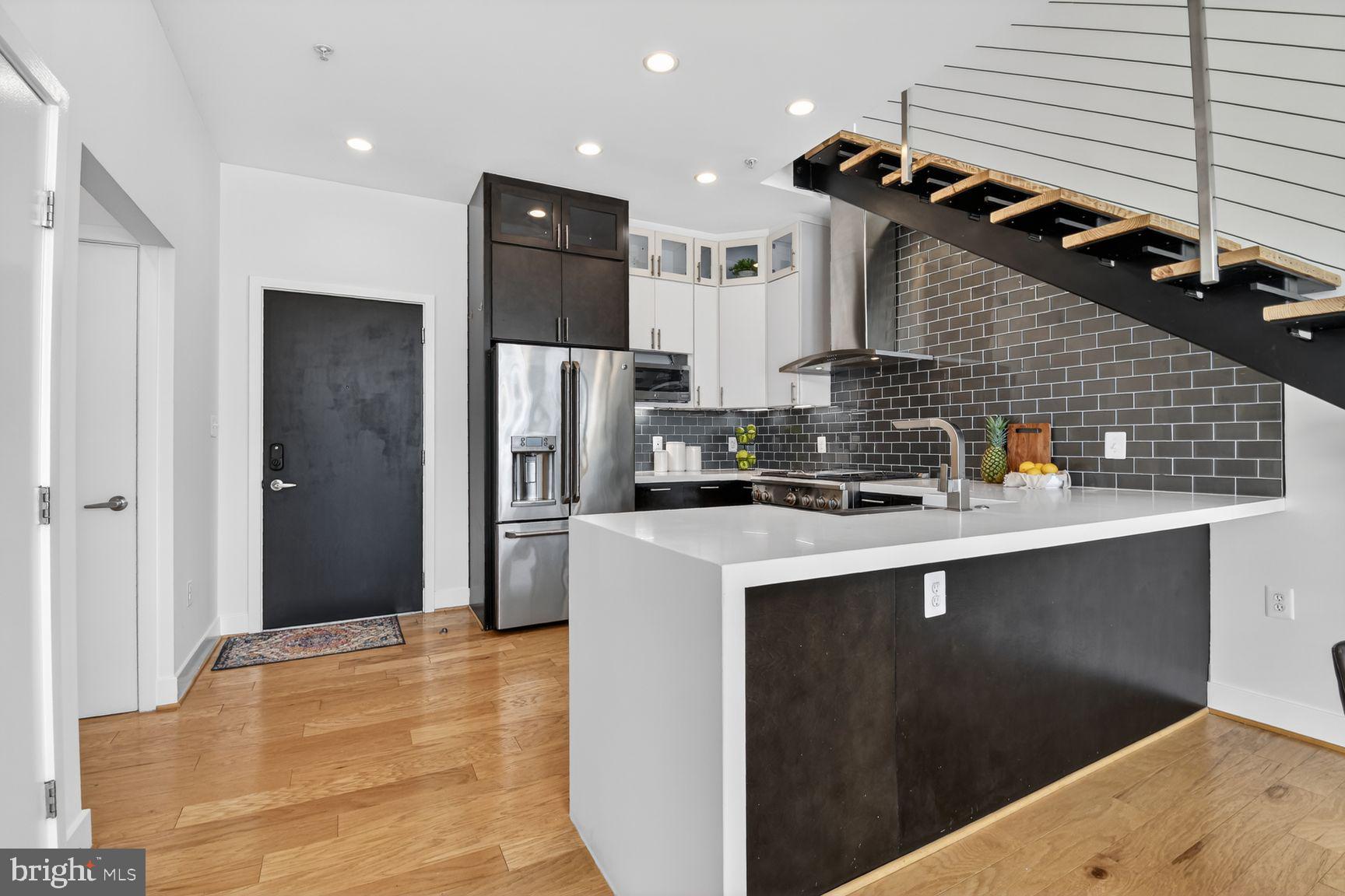 1443 Chapin Street Northwest, Unit 403 Washington, DC 20009 - Photo 8 of 24 a kitchen with stainless steel appliances granite countertop a refrigerator a sink and a stove