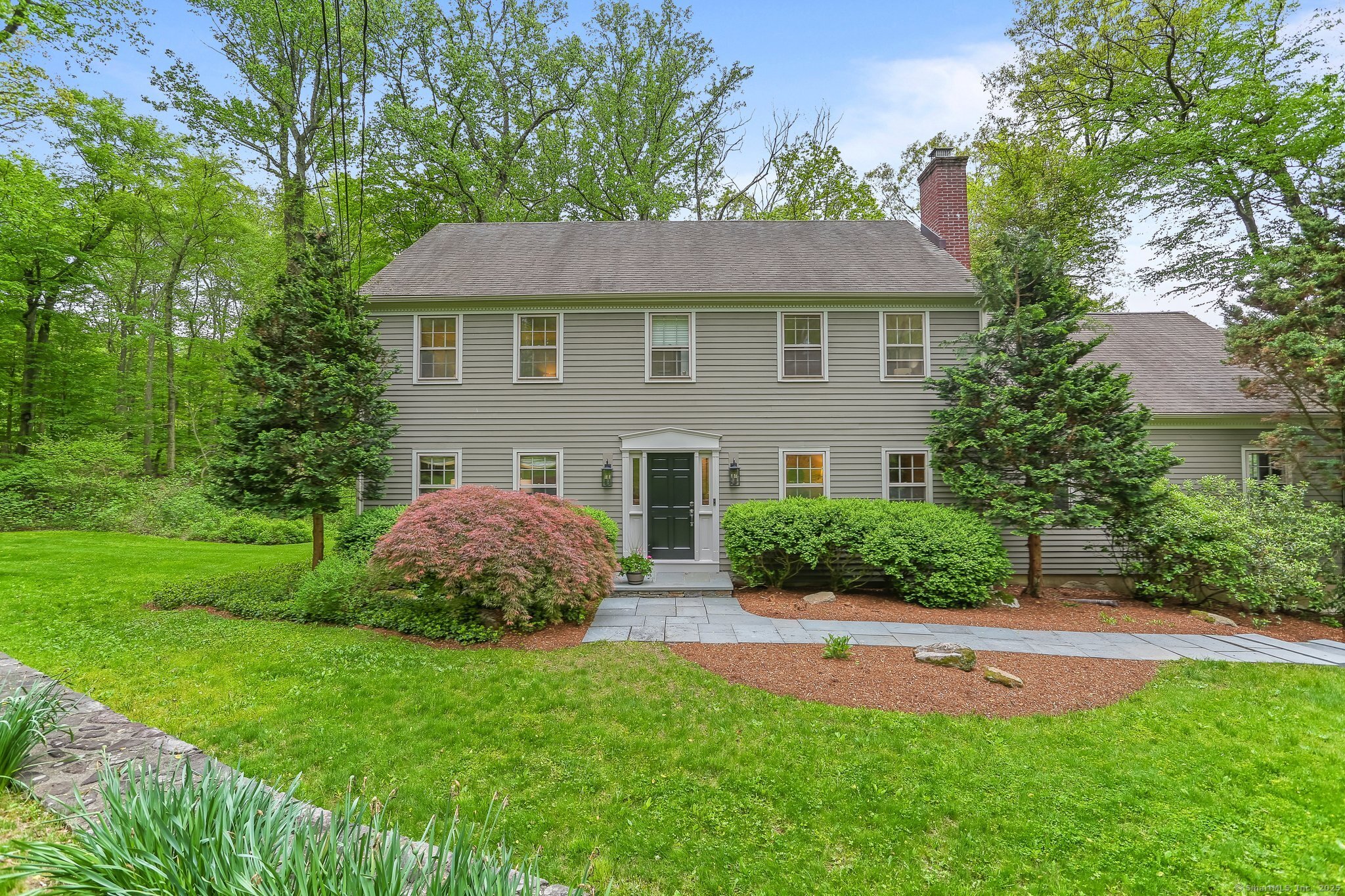 a aerial view of a house next to a yard