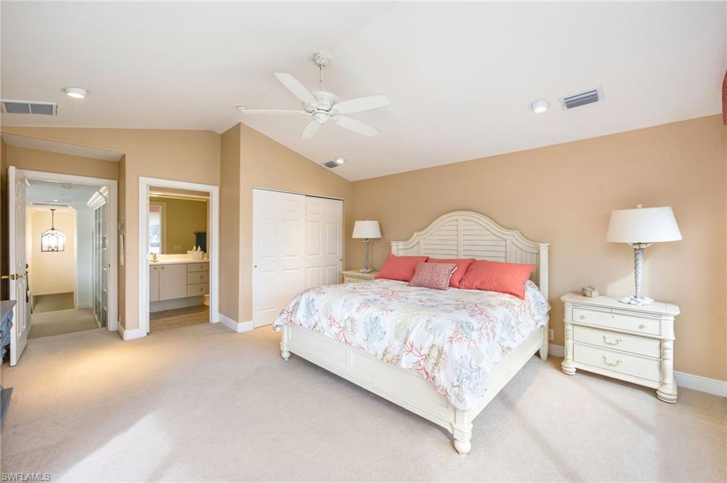 6012 Fairway Court Naples, FL 34110 - Photo 16 of 38 a bedroom with a bed and a lamp