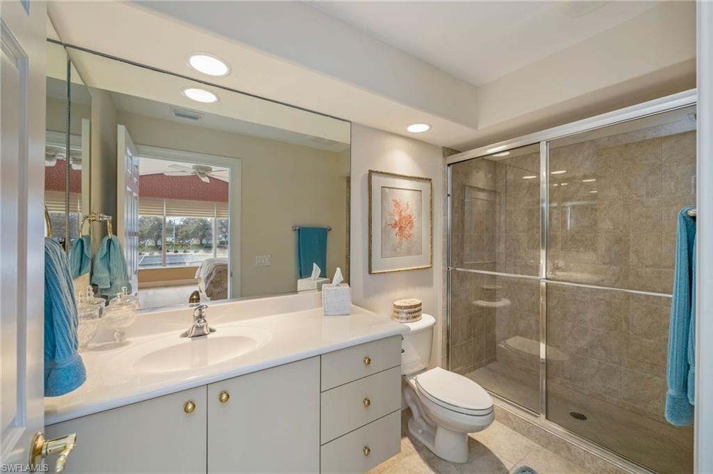 6012 Fairway Court Naples, FL 34110 - Photo 17 of 38 a bathroom with a toilet sink and shower