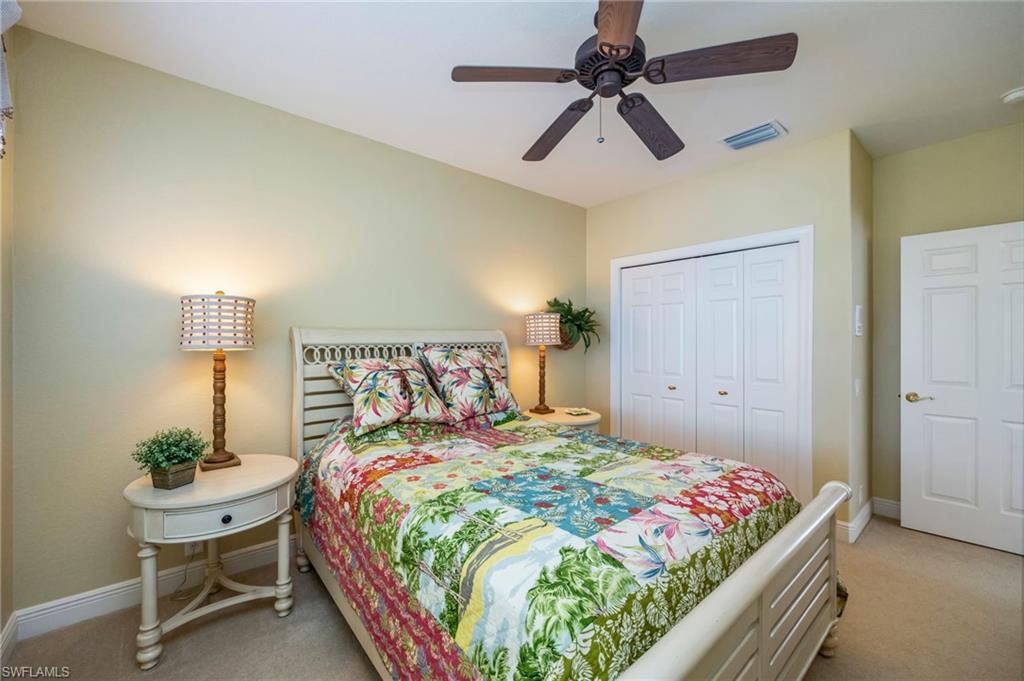 6012 Fairway Court Naples, FL 34110 - Photo 18 of 38 a bedroom with a bed and a table in it