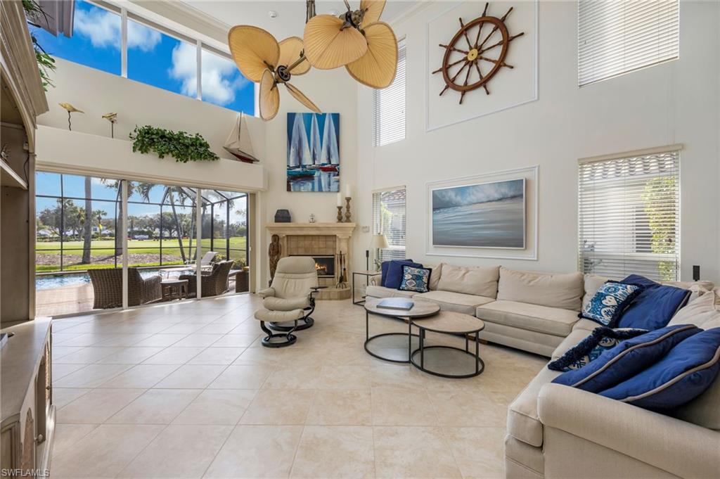 6012 Fairway Court Naples, FL 34110 - Photo 4 of 38 a living room with furniture and a floor to ceiling window